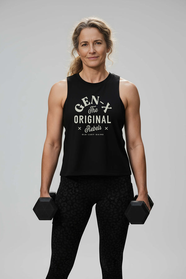 Confident Gen-X woman in her 40s wearing a vintage-style muscle tank that reads Gen-X The Original Rebels, standing strong with a smirk.