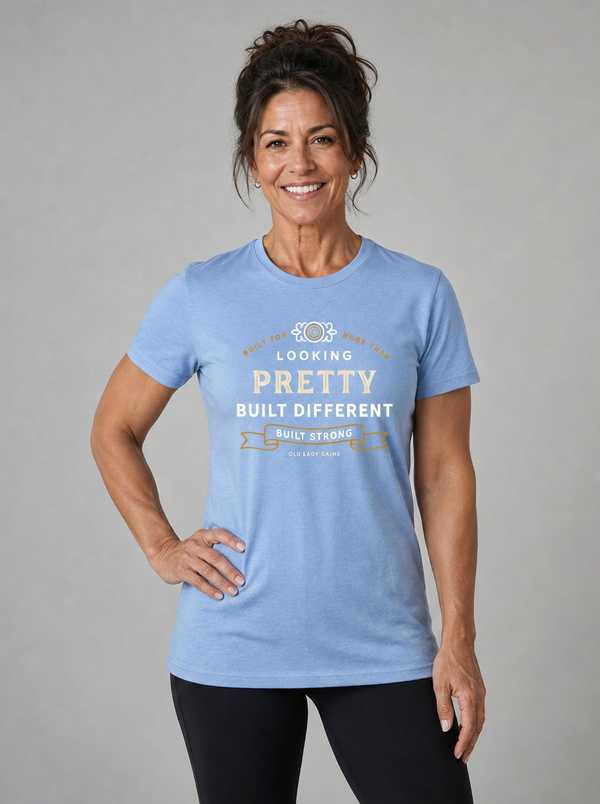 Confident woman over 50 wearing the Built for More Than Looking Pretty built different blue tshirt