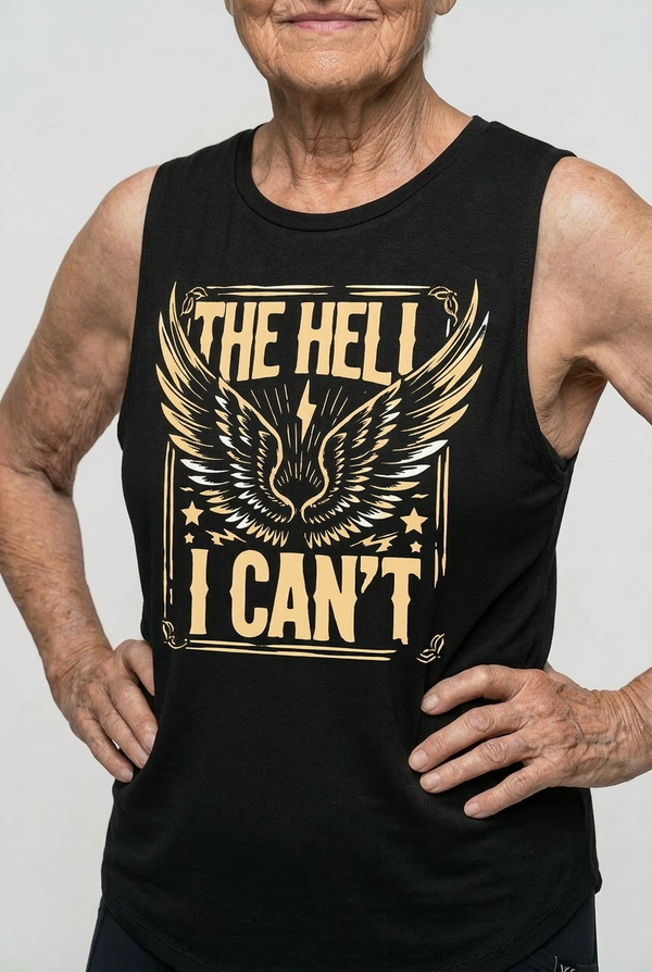 Woman over 40 wearing a black tank top with gold graphic and text against a plain background
