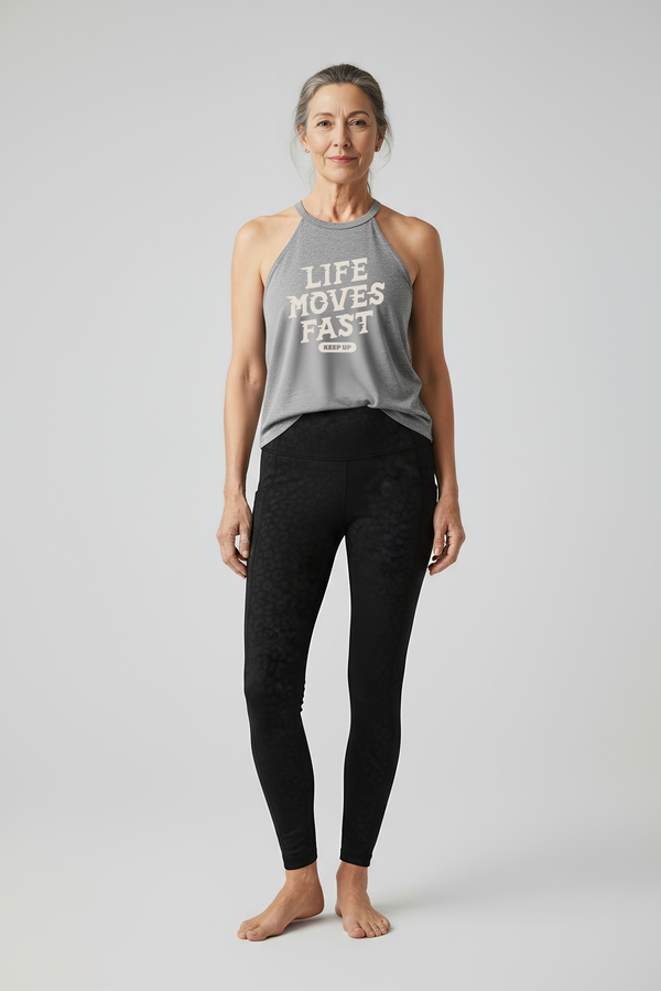 Active woman over 60 wearing Life Moves Fast Keep Up grey halter tank.