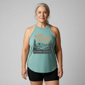 Woman wearing an old lady gains eucalyptus halter tank top with a graphic that reads never outgrow playing outside