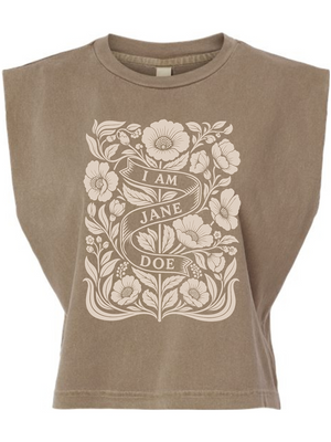 A cropped, sleeveless t-shirt in a washed taupe-brown color, featuring a large cream-colored botanical graphic on the front with a banner that reads 'I AM JANE DOE'.