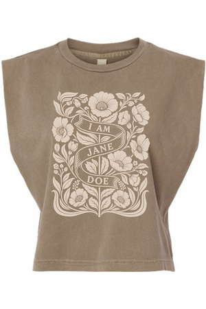 A cropped, sleeveless t-shirt in a washed taupe-brown color, featuring a large cream-colored botanical graphic on the front with a banner that reads 'I AM JANE DOE'.