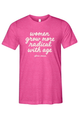 A heather pink short-sleeve t-shirt with white script text reading 'women grow more radical with age -gloria strauss' on the front, displayed against a solid white background.