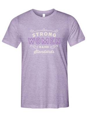 Purple t-shirt with motivational text that read strong women raise standards on a white background