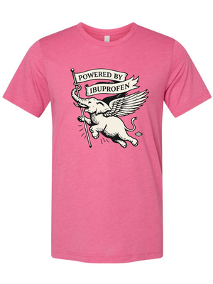 Pink t-shirt with a graphic of an elephant holding a banner and text 'Powered by Ibuprofen' on a white background.