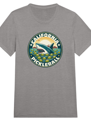 Vintage California pickleball t-shirt graphic featuring a great white shark swimming through floating pickleballs with bold retro typography.