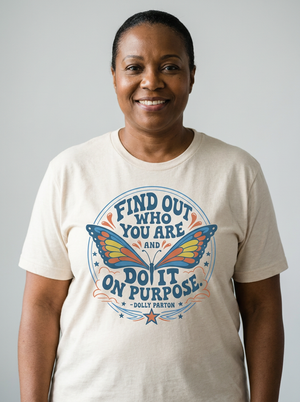 cream unisex t-shirt with a blue and orange butterfly graphic and Dolly Parton quote "Find out who you are and do it on purpose"