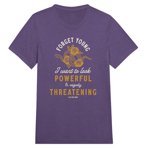 Woman wearing a purple heathered t-shirt that reads Forget Young I want to look powerful & vaguely threatening with a snake and roses on it.