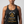 A woman wearing a dark heather gray racerback tank top with a gold and white graphic print that reads 'FORGET YOUNG I want to look POWERFUL & VAGUELY THREATENING' with a snake illustration. The brand 'Old Lady Gains' is printed at the bottom of the graphic.