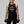 Confident Gen-X woman in her 40s wearing a vintage-style muscle tank that reads Gen-X The Original Rebels, standing strong with a smirk.