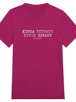 A pink crew neck t-shirt with the text 'Kinda Vintage Kinda Savage' printed on the front.