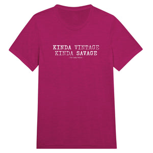 A pink crew neck t-shirt with the text 'Kinda Vintage Kinda Savage' printed on the front.
