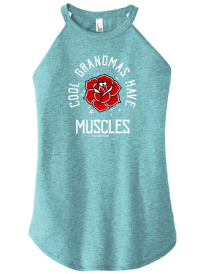 A woman wearing a navy blue high-neck halter tank top with text and a graphic on it that reads Cool Grandmas Have Muscles