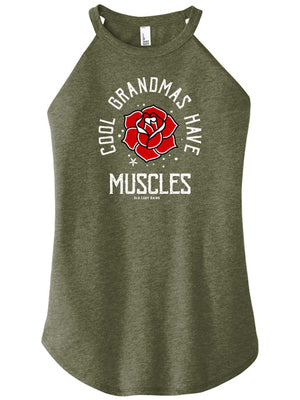 A woman wearing a military green high-neck halter tank top with text and a graphic on it that reads cool grandmas have muscles around a rose.