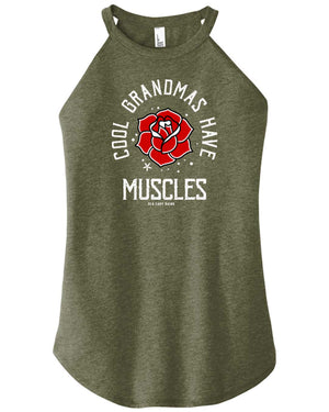 A woman wearing a military green high-neck halter tank top with text and a graphic on it that reads cool grandmas have muscles around a rose.