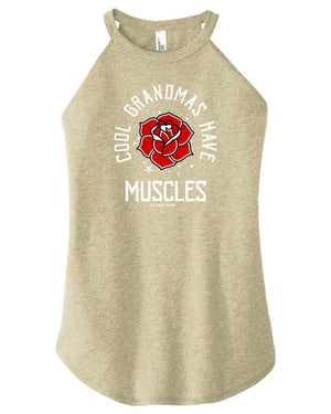 A woman wearing a tan high-neck halter tank top with text and a graphic on it.