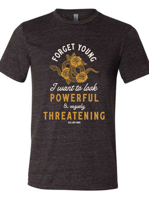Close up of a black heathered t-shirt that reads Forget Young I want to look powerful & vaguely threatening with a snake and roses on it.