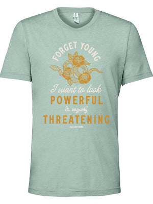 Close up of a mint heathered t-shirt that reads Forget Young I want to look powerful & vaguely threatening with a snake and roses on it.