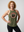 Middle-aged Woman wearing a green tank top with a logo and text that reads REMEMBER ONLY YOU CAN AGE STRONG on a plain background