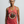 Middle-aged woman wearing a red tank top with a graphic design that says REMEMBER ONLY YOU CAN AGE STRONG>