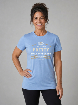 Confident woman over 50 wearing the Built for More Than Looking Pretty built different blue tshirt