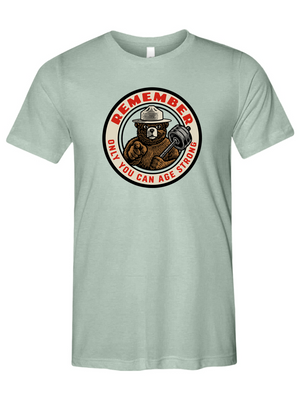 Light green t-shirt with a bear and barbell graphic and text on a white background
