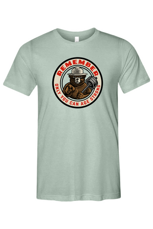 Light green t-shirt with a bear and barbell graphic and text on a white background
