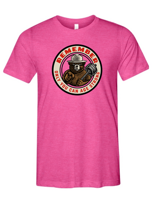 Pink t-shirt with a bear graphic and text on a white background