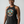A woman wearing a dark heather gray halter tank top with a colorful circular 'Red Rover Survivor' graphic on the chest, set against a plain light gray background.