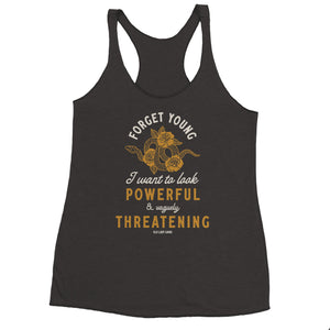 dark heather gray racerback tank top with a gold and white graphic print that reads 'FORGET YOUNG I want to look POWERFUL & VAGUELY THREATENING' with a snake illustration. The brand 'Old Lady Gains' is printed at the bottom of the graphic.