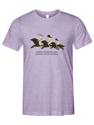 A heather purple short-sleeve crewneck t-shirt featuring a vintage-style graphic of three women riding horses with the text 'RAISED UNGOVERNABLE. RAISING UNGOVERNABLE.