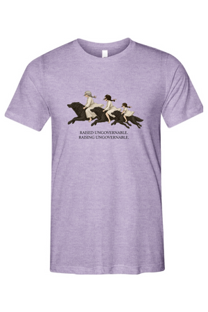 A heather purple short-sleeve crewneck t-shirt featuring a vintage-style graphic of three women riding horses with the text 'RAISED UNGOVERNABLE. RAISING UNGOVERNABLE.
