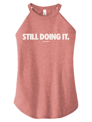 Red tank top with 'STILL DOING IT.' text on a white background