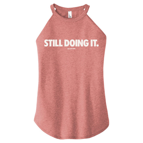 Red tank top with 'STILL DOING IT.' text on a white background