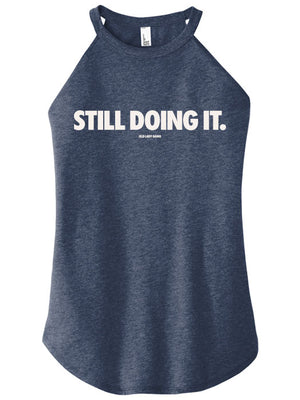 Navy tank top with 'STILL DOING IT.' text on a white background