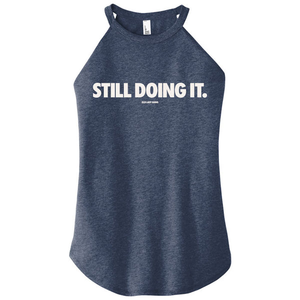 Navy tank top with 'STILL DOING IT.' text on a white background