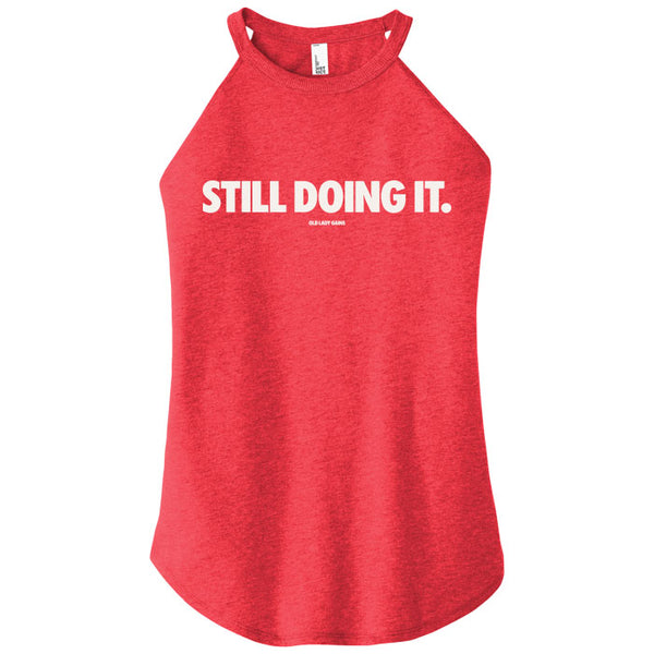 Red tank top with 'STILL DOING IT.' text on a white background