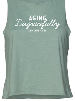 Fun and empowering "Aging Disgracefully" text print on a mint crop tank top