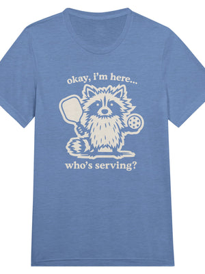 Funny pickleball graphic featuring a raccoon holding a paddle and pickleball with the text “Okay, I’m Here… Who’s Serving?”
