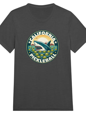 Vintage California pickleball t-shirt graphic featuring a great white shark swimming through floating pickleballs with bold retro typography.