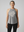 Active woman over 60 wearing Life Moves Fast Keep Up grey halter tank.