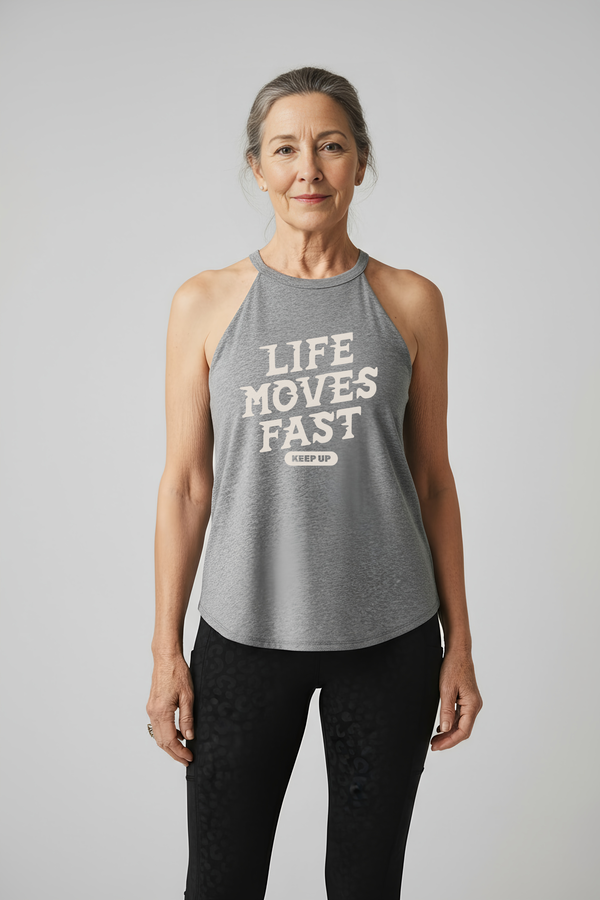 Active woman over 60 wearing Life Moves Fast Keep Up grey halter tank.