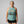Woman wearing an old lady gains eucalyptus halter tank top with a graphic that reads never outgrow playing outside