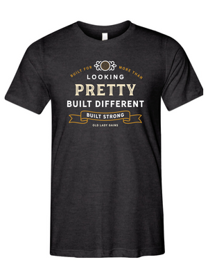 Woman's charcoal black halter t-shirt reading "Built for More Than Looking Pretty. Built Different. Built Strong." by Old Lady Gains, motivational fitness apparel for women over 40.