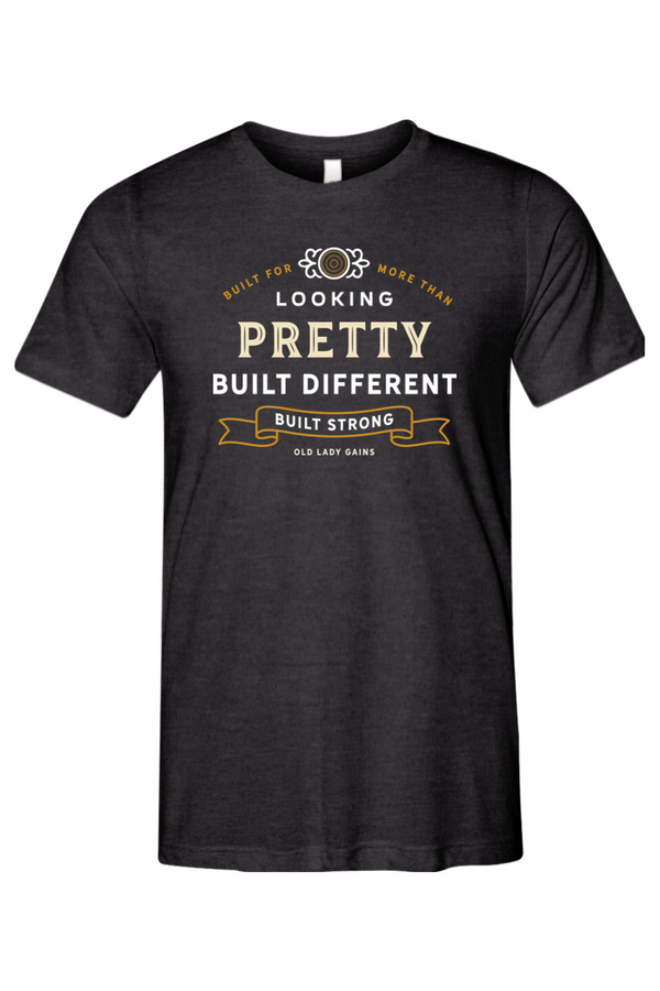 Woman's charcoal black halter t-shirt reading "Built for More Than Looking Pretty. Built Different. Built Strong." by Old Lady Gains, motivational fitness apparel for women over 40.