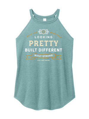 Woman's eucalyptus halter tank top reading "Built for More Than Looking Pretty. Built Different. Built Strong." by Old Lady Gains, motivational fitness apparel for women over 40.