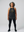 middle aged woman wearing a black tank halter tank top with a graphic design of historic woman harriet tubman deadlifting