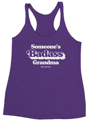 Product view of a purple racerback tank with printed "Someone's Badass Grandma" 