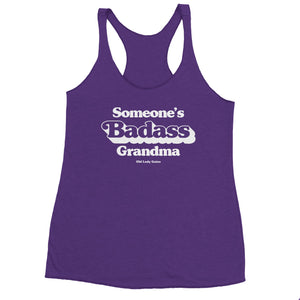 Product view of a purple racerback tank with printed "Someone's Badass Grandma" 